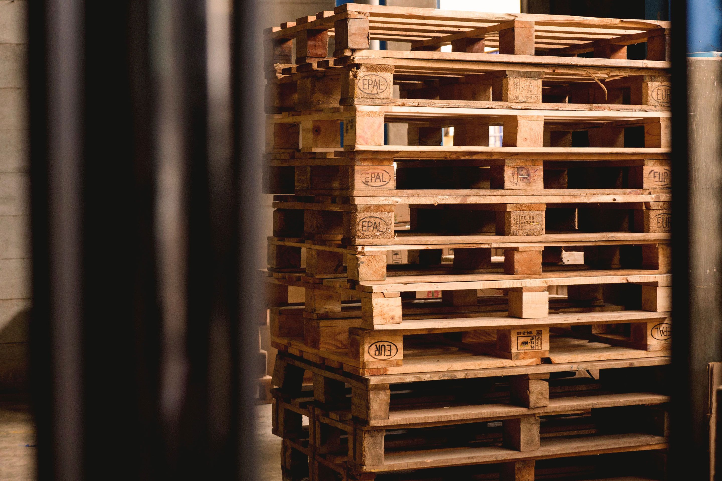 stack of wooden pallets with EPAL and EUR markings in a warehouse