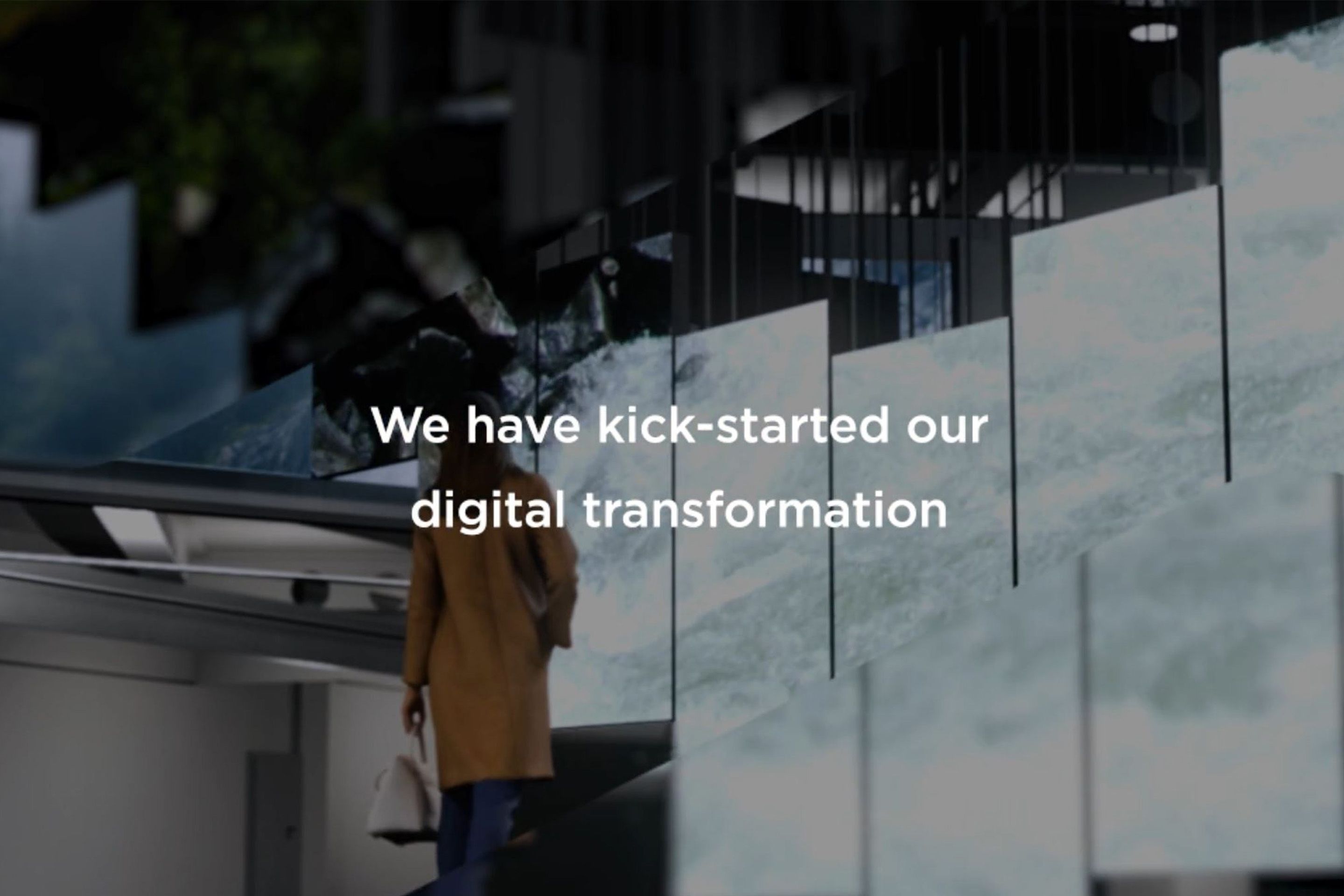 Person walking up stairs with digital water-like display and text about digital transformation