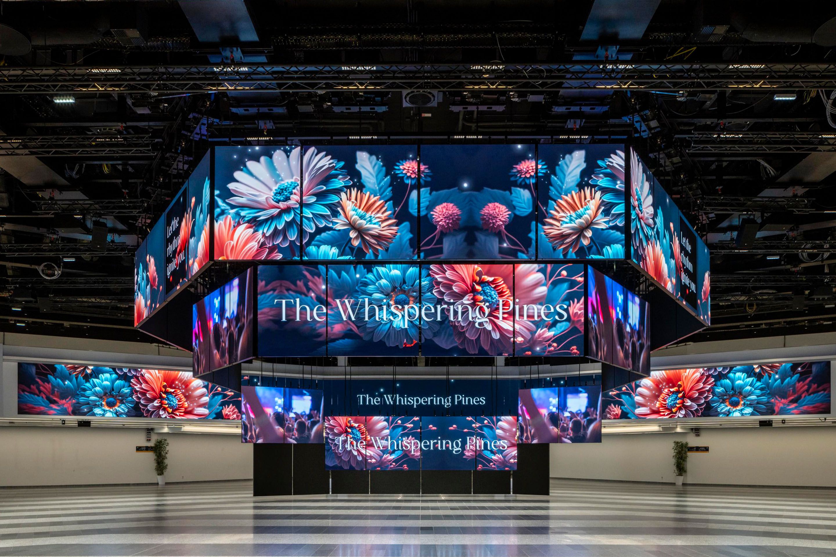 Colorful floral digital displays with the text The Whispering Pines in a large hall