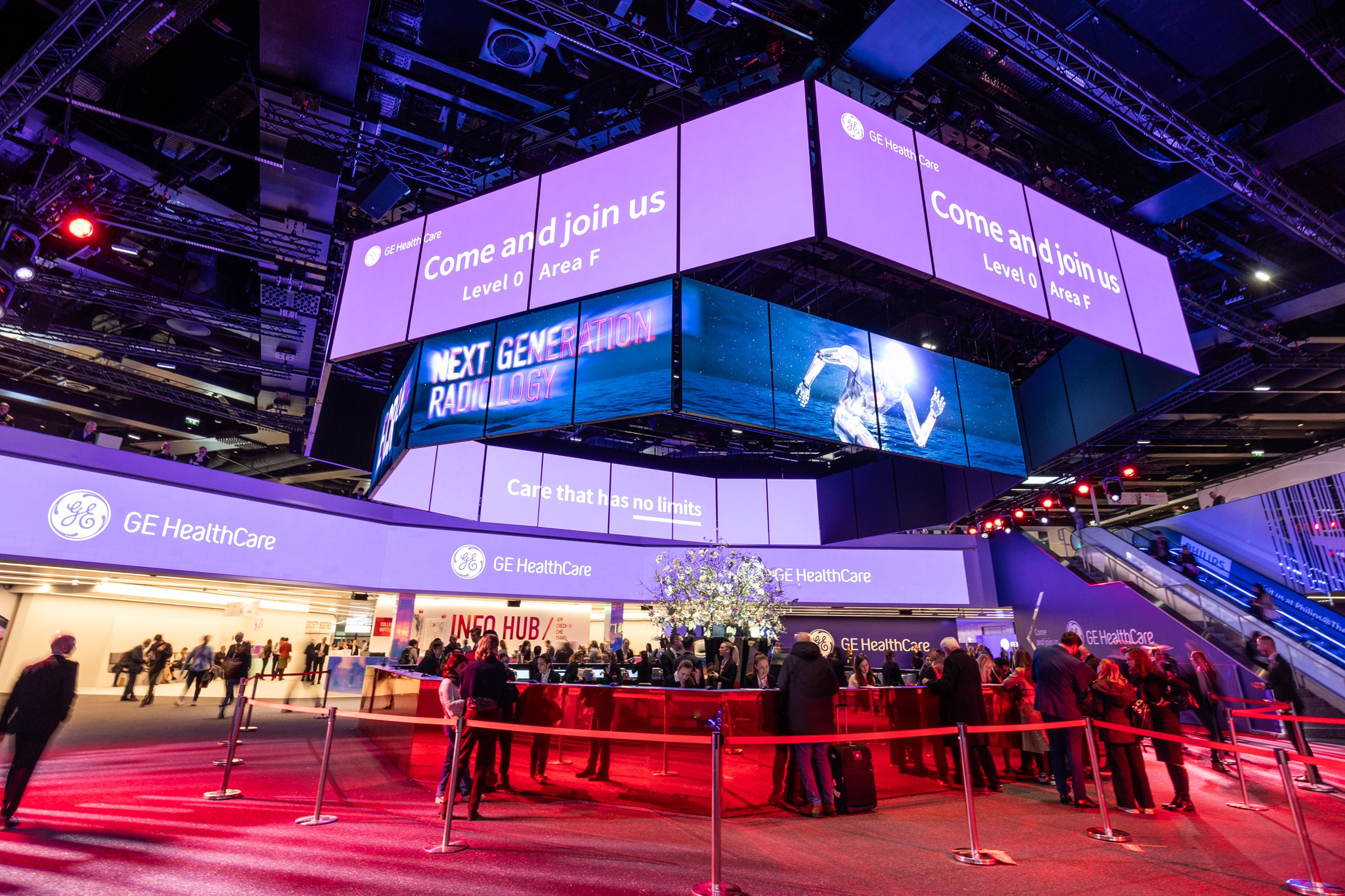 GE HealthCare booth with digital screens displaying "Come and join us" and "Next Generation Radiology"