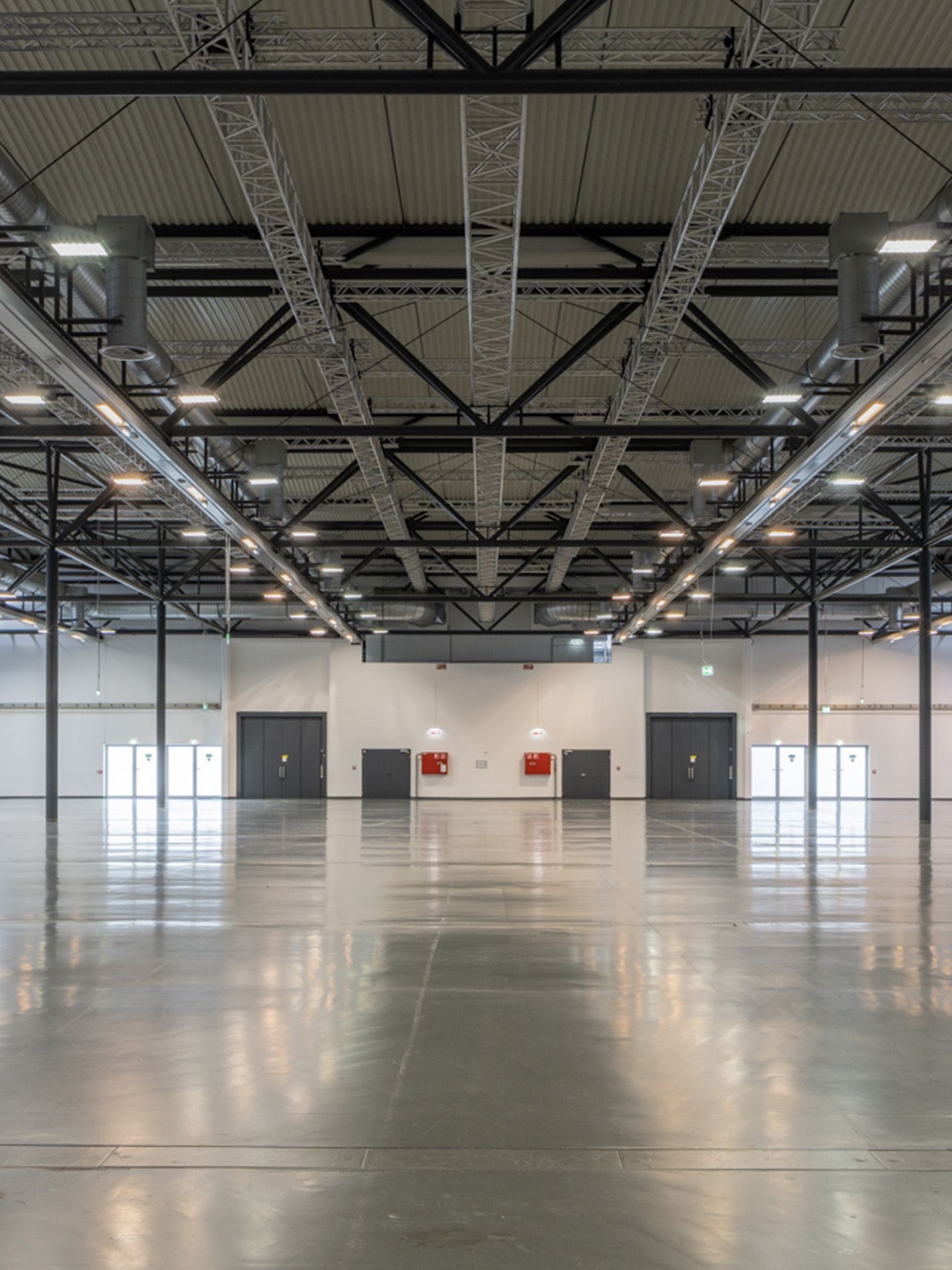 Foto: Halle mit hellem Boden und Saeulen und dunkler Decke