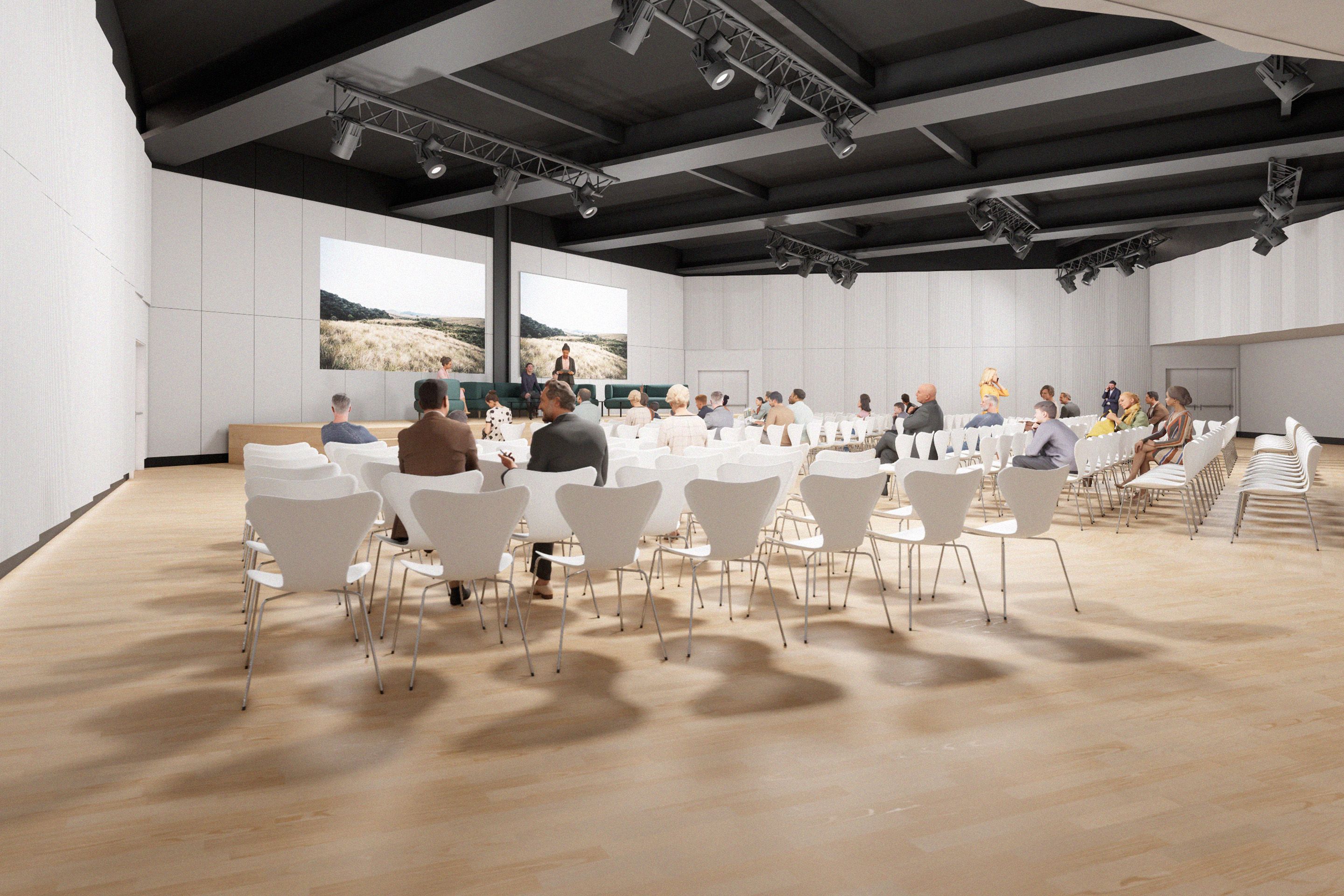 Mockup: einige Menschen sitzen auf weissen Stuehlen in einem Raum mit einer Leinwand. Auf der Buehne eine Moderatorin