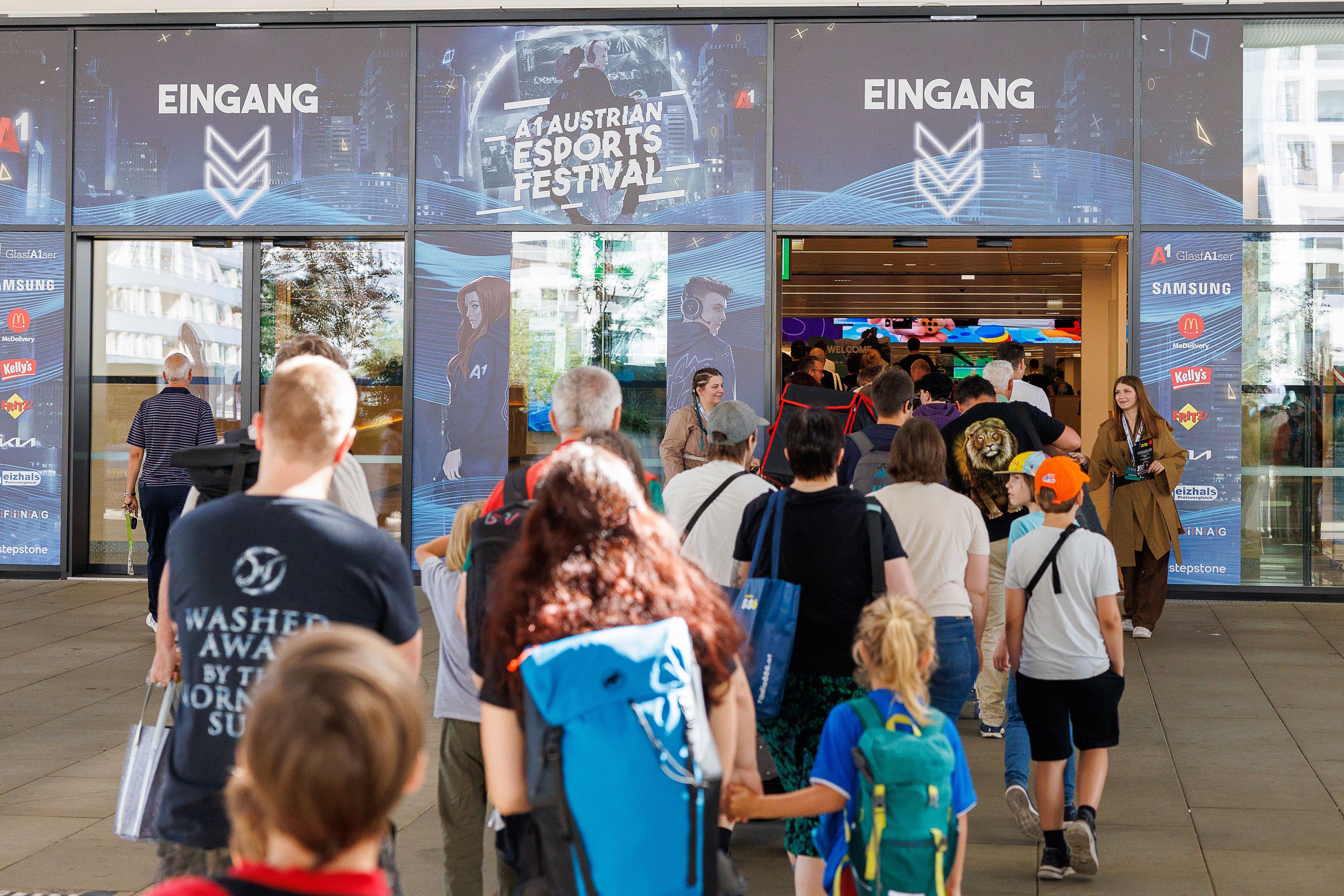 Besucherinnen betreten den Eingang 1 des Austria Center Vienna zum A1 E-Sport Festival und Spielefest 2024.
